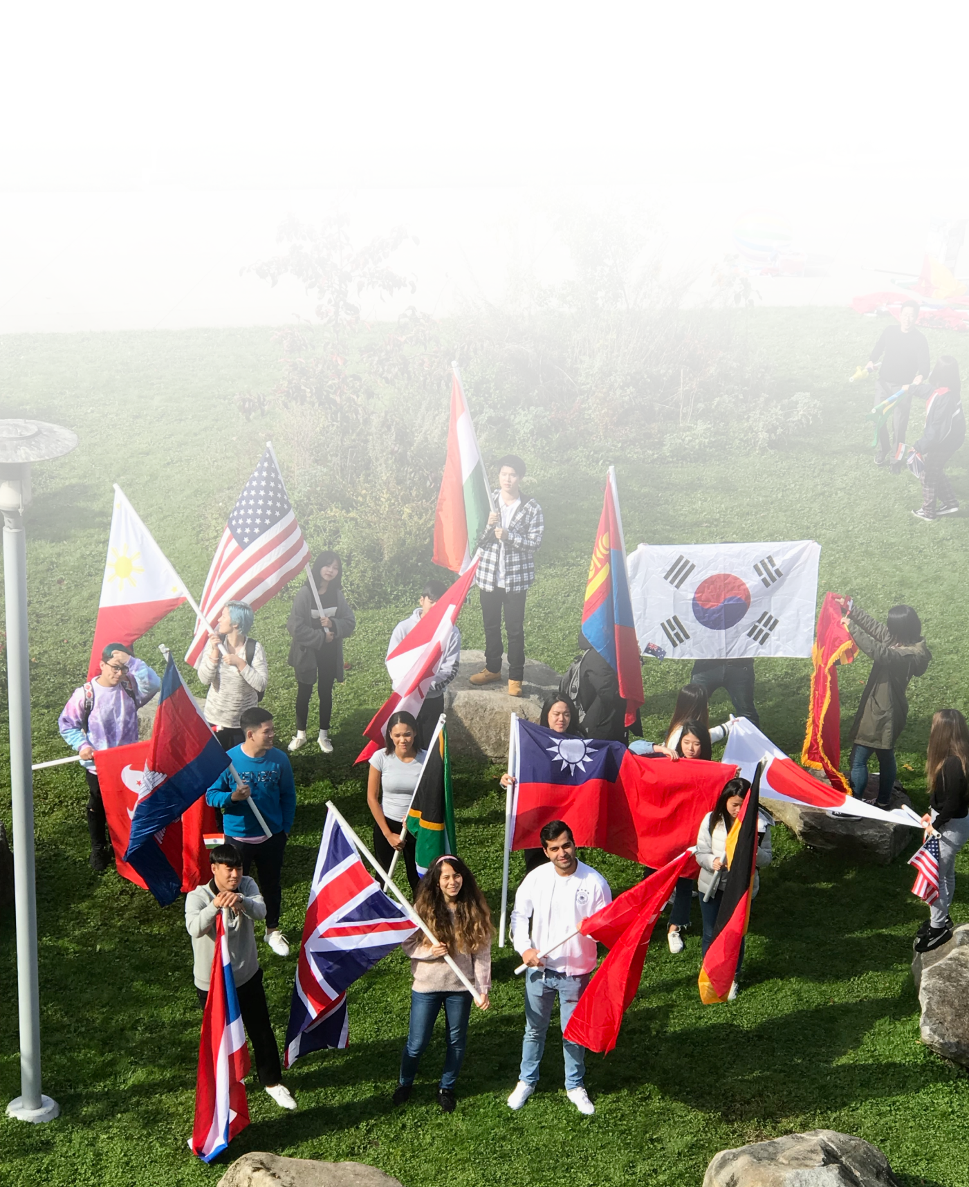 Students wave various national flags